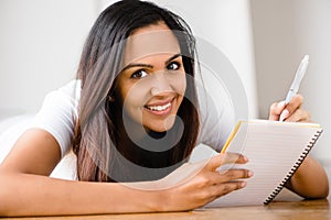 Happy Indian woman student education writing studying