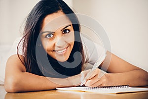 Happy Indian woman student education writing studying