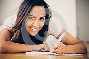 Happy Indian woman student education writing studying