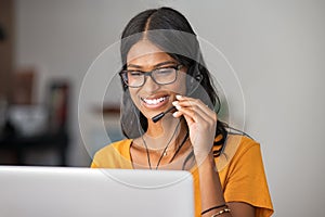 Happy indian woman working in a call center