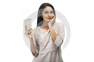 Happy Indian Young Woman with Indian Currency Against White Background