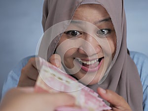 Happy Indonesian Muslim Woman Receiving Rupiah Money