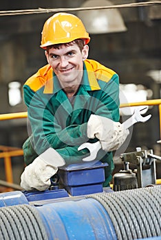 Happy industry worker repairman with spanner