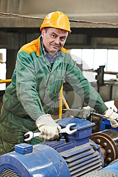 Happy industry worker repairman with spanner