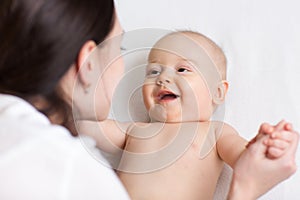 Happy infant baby looking at mom
