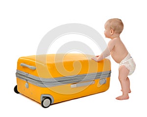 Happy infant baby toddler sitting in yellow plastic travel suitcase