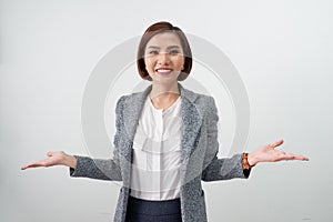 Happy inspired businesswoman dressed in office clothes looking at the camera surprisingly and smiling open arms on white