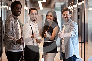 Happy international business people group showing thumbs up, portrait