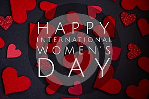 Happy International Women`s Day lettering with white text on black background with red heart