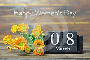 Happy International Womens Day card. Wooden calendar and orange chrysanthemum flowers