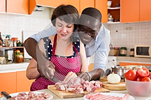 Happy interracial couple cooking