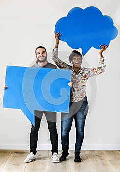 Happy interracial couple holding copyspace speech bubble