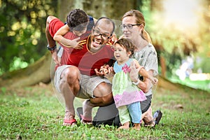 Happy interracial family is being active a day in the park photo