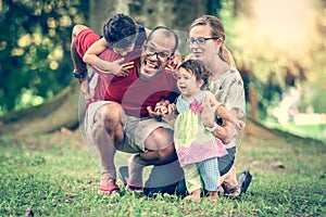 Happy interracial family is being active a day in the park