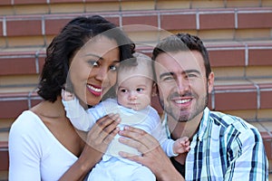 Happy interracial family is celebrating, laughing and having fun with Hispanic African American Mother