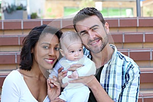 Happy interracial family is celebrating, laughing and having fun with Hispanic African American Mother