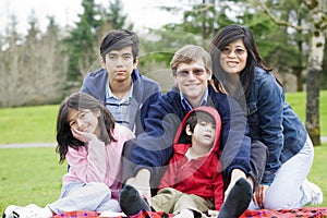Happy interracial family enjoying day at park
