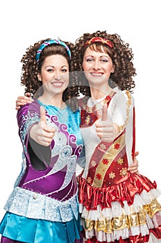 Happy Irish dancers showing thumbs up sign