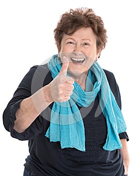 Happy isolated older lady wearing blue clothes with thumb up gesture over white.