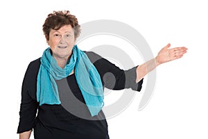 Happy isolated senior woman presenting over white.