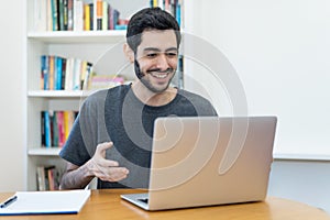 Happy israeli IT specialist at work at computer