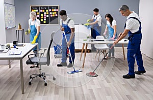 Happy Janitors Cleaning Office