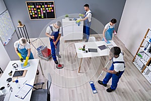 Happy Janitors Cleaning Office