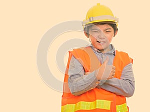 Happy Japanese boy construction worker smiling and winking while giving thumb up