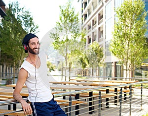 Happy jogger relaxing with music on headphones