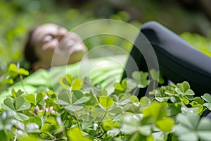 happy jogger resting in meadow with clovers