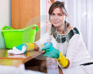 Happy joyful adult brunette dusting with cleanser