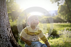 Happy joyful Asia Chinese little boy toddler child enjoy Spring have fun outside embrace nature outdoor carefree childhood meadow