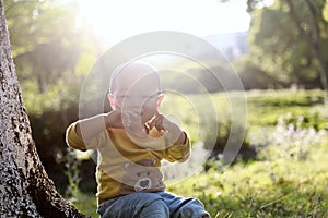 Happy joyful Asia Chinese little boy toddler child enjoy Spring have fun outside embrace nature outdoor carefree childhood meadow