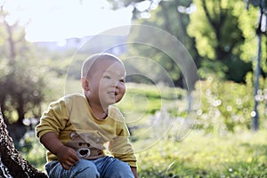 Happy joyful Asia Chinese little boy toddler child enjoy Spring have fun outside embrace nature outdoor carefree childhood meadow