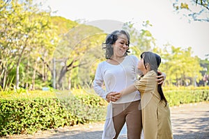 Happy and joyful Asian grandmother and granddaughter showing love, hugging