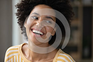 Happy joyful Black girl looking away with toothy smile