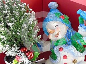 Happy joyful Christmas snowman skating around a Xmas tree