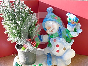 Happy joyful Christmas snowman skating round a xmas tree photo