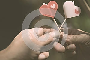 Happy joyful couple give heart candle to each other in the afternoon, Love concept