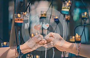 Happy joyful couple give heart candle to each other in front of candle light, Love concept