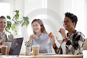 Happy joyful diverse business people laughing talking at work break