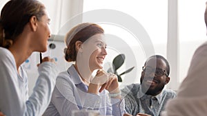 Happy joyful diverse business people talking laughing at funny joke photo