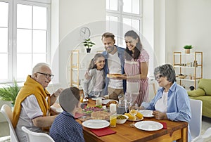 Happy, joyful family celebrating something and enjoying meal all together at home