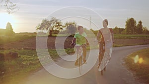 Happy joyful family riding bicycles in the park.