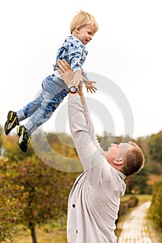 Happy joyful father having fun throws up in the air child. Family, travel, vacation, father`s day concept.