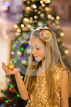 Happy joyful girl on the background of the New Year tree. Merry Christmas