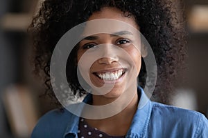 Happy joyful girl looking at camera with toothy smile photo