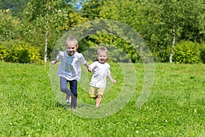 Happy joyful kids running on the grass