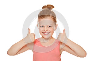 Happy joyful little girl smiling showing thumbs up, isolated on white background