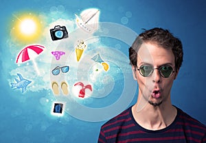 Happy joyful man with sunglasses looking at summer icons